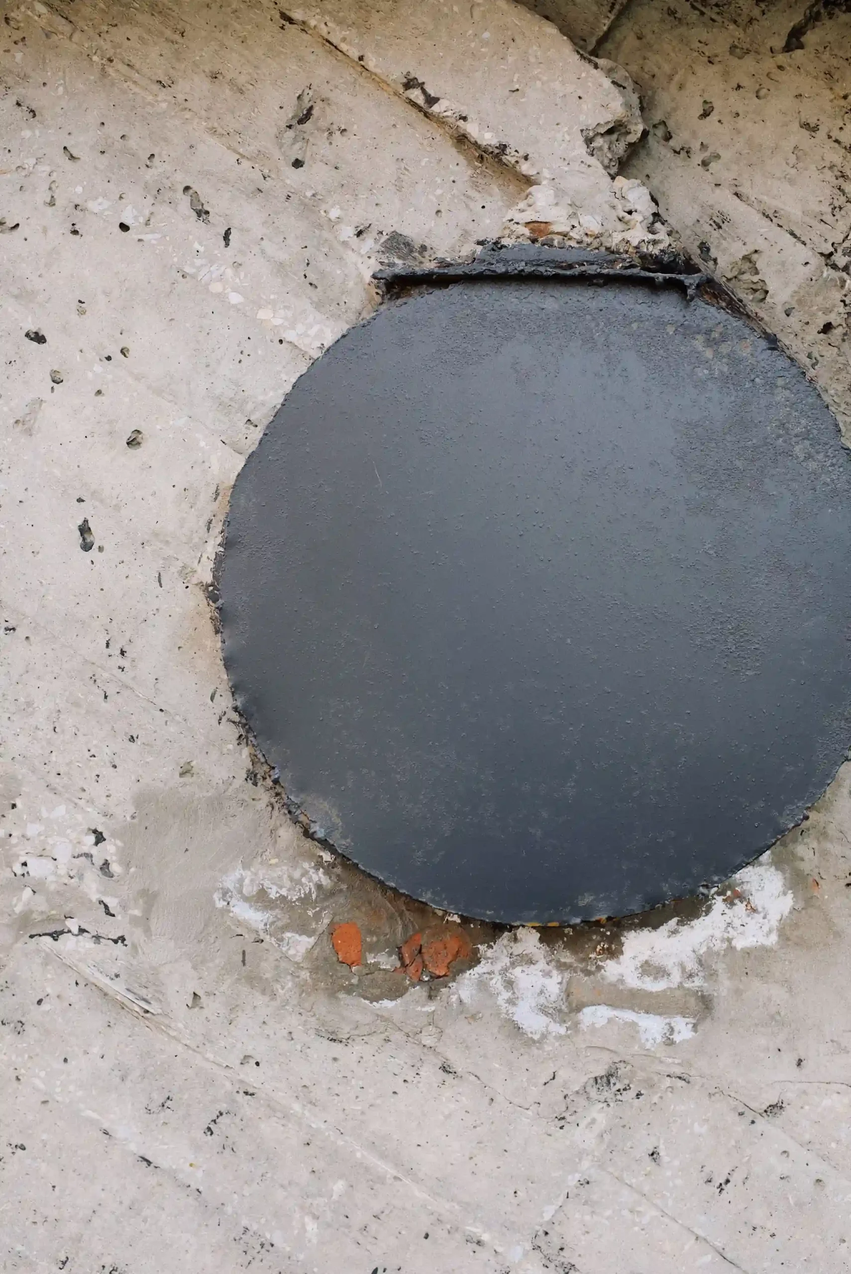 Pothole patched with fresh asphalt